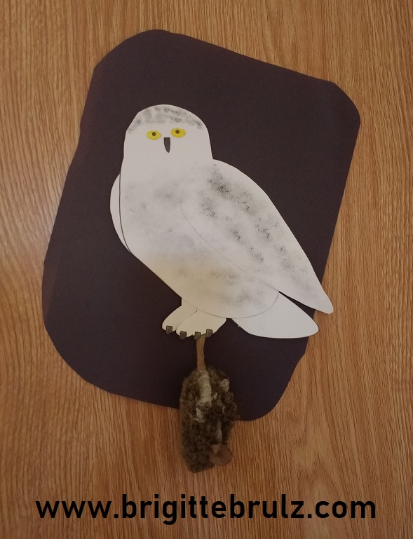 snowy owl with mouse